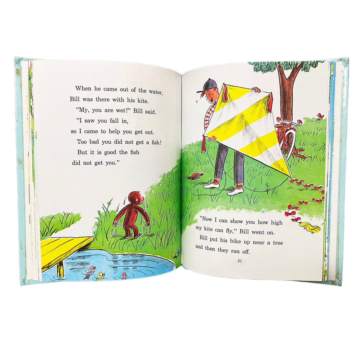 Open book with illustrated pages showing a boy and monkey with a kite by a pond