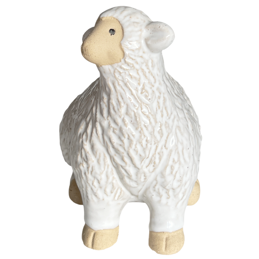 White ceramic sheep figurine on a white background