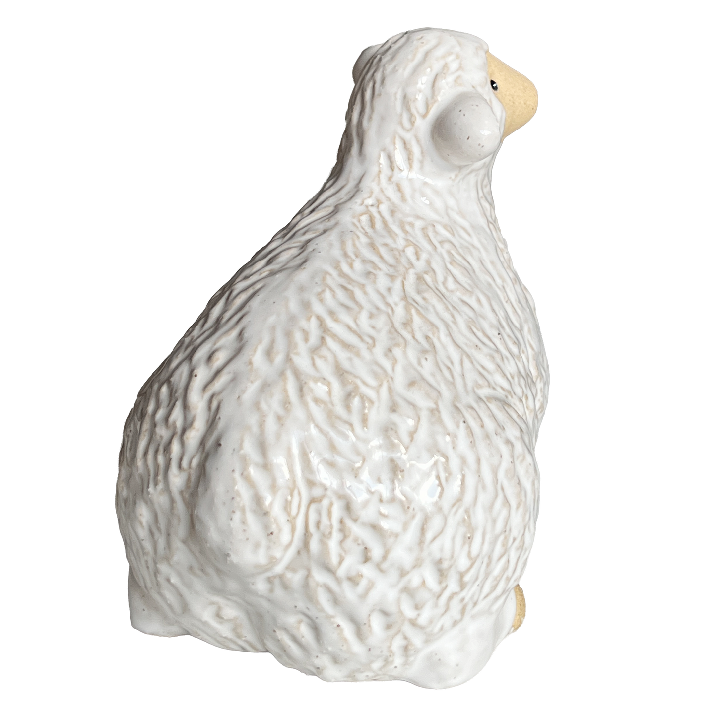 White ceramic sheep figurine view from the back.