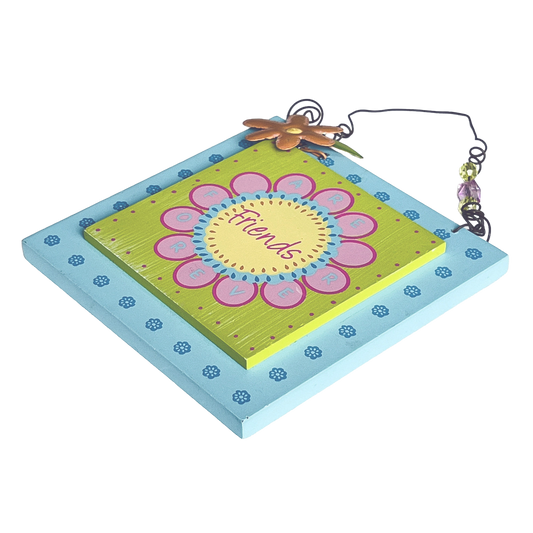 Decorative wall hanging with a floral design and 'Friends' text on a white background