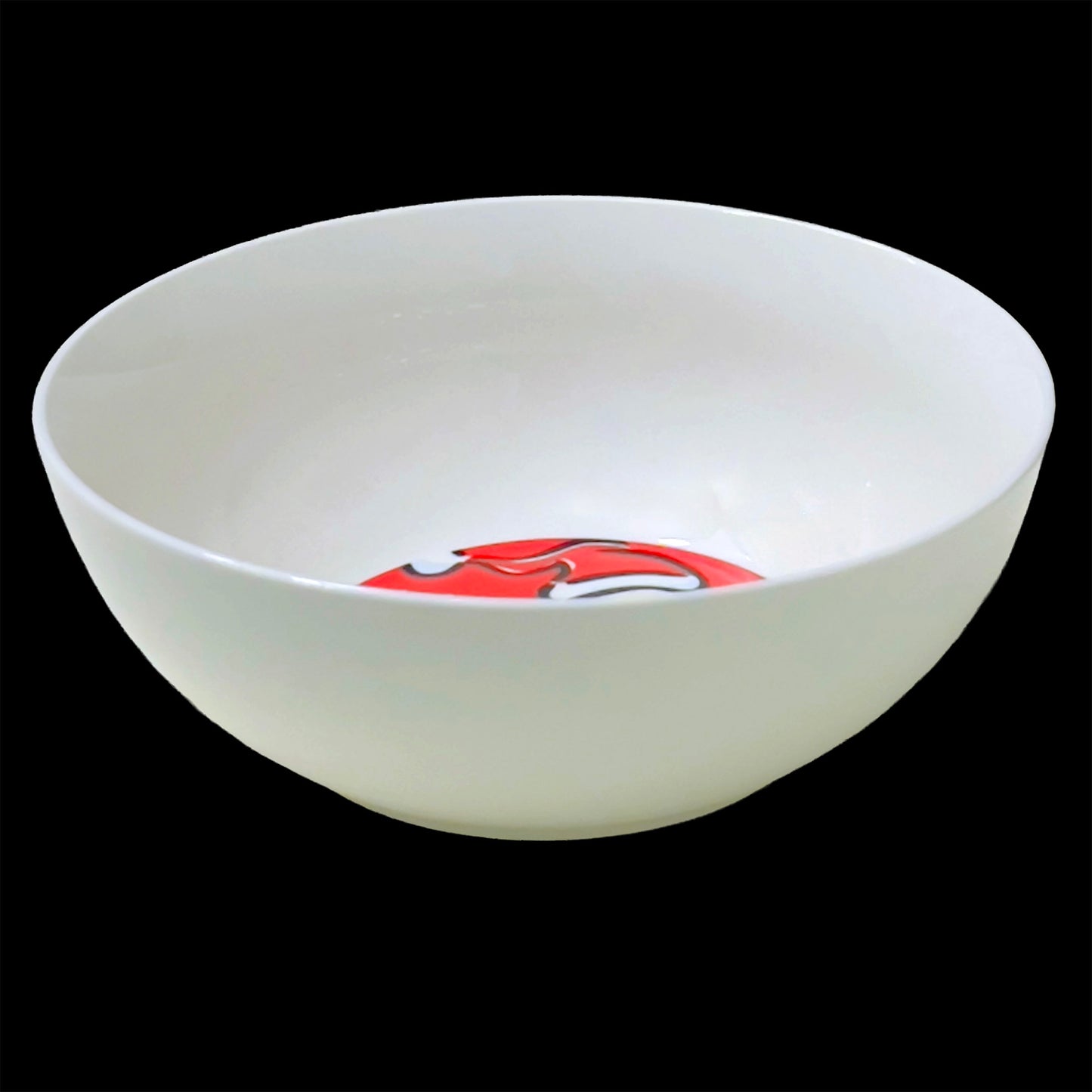 White ceramic bowl with a red and white design on a black background