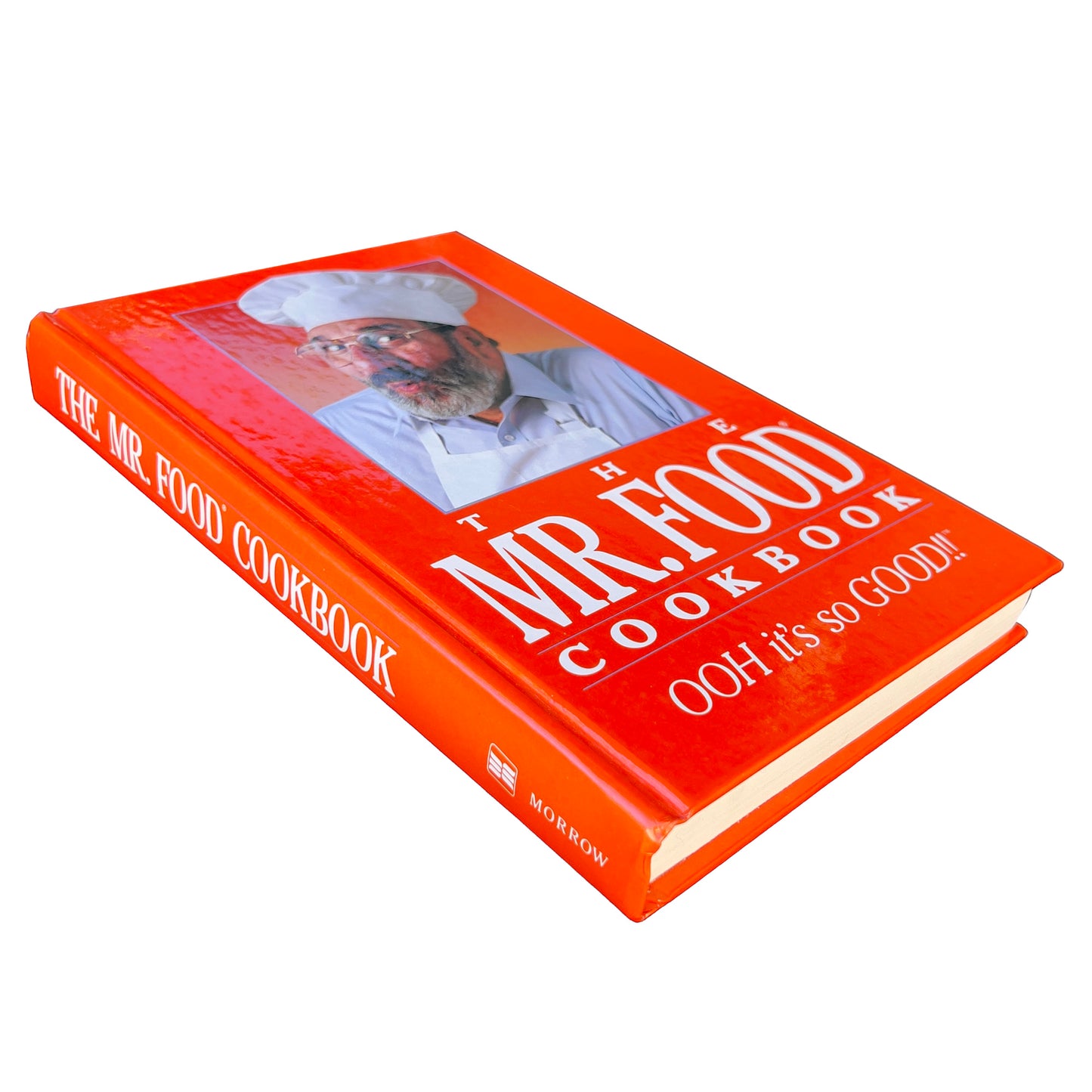 Orange cookbook titled 'The Mr. Food Cookbook' on a white background