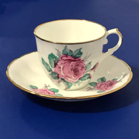 Jason-bone-china-collectible-teacup-and-saucer-set,-#J554,-featuring-pink-roses-and-green-leaves,-accented-by-gilt-trim-on-the-edge-of-the-cup-and-saucer.-Excellent-condition.-Makes-a-great-gift.-Shop-eBargainsAndDeals.com.