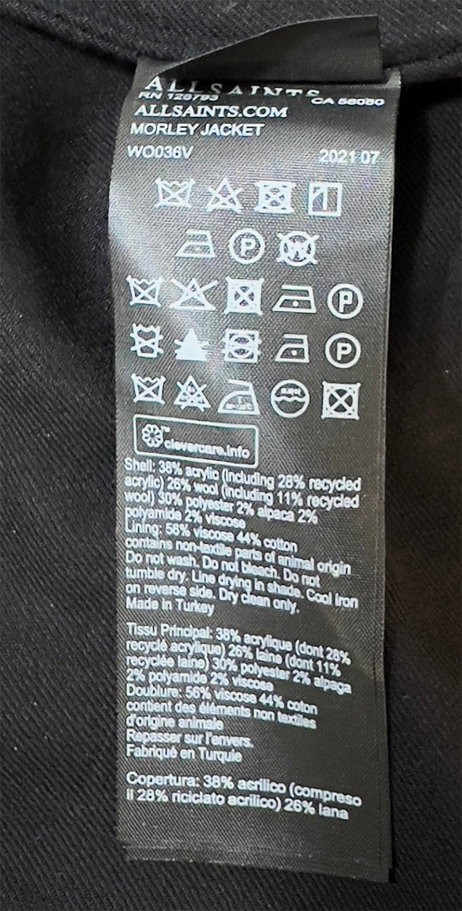 Clothing label with brand details and care instructions on a plaid jacket.