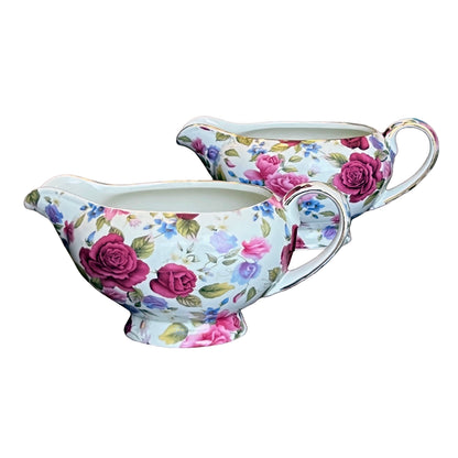Floral-patterned gravy boat and creamer set on a white background