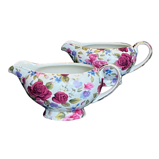 Floral-patterned gravy boat and creamer set on a white background