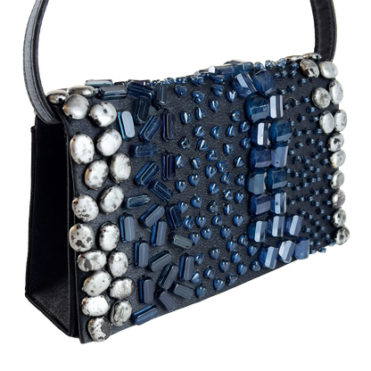Black handbag with blue and silver bead embellishments on a white background