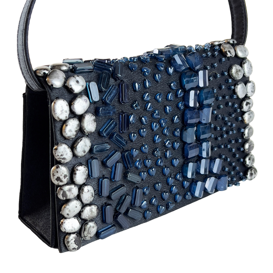 Black handbag with blue and silver bead embellishments on a white background