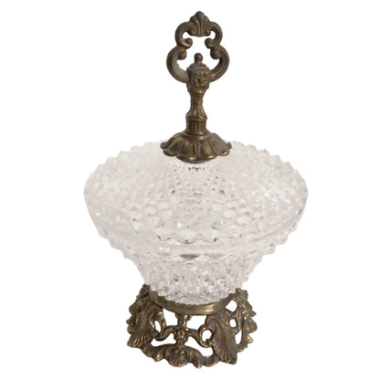 Decorative glass bowl with ornate bronze base on a white background