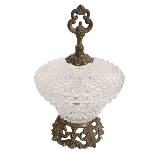 Decorative glass bowl with ornate bronze base on a white background