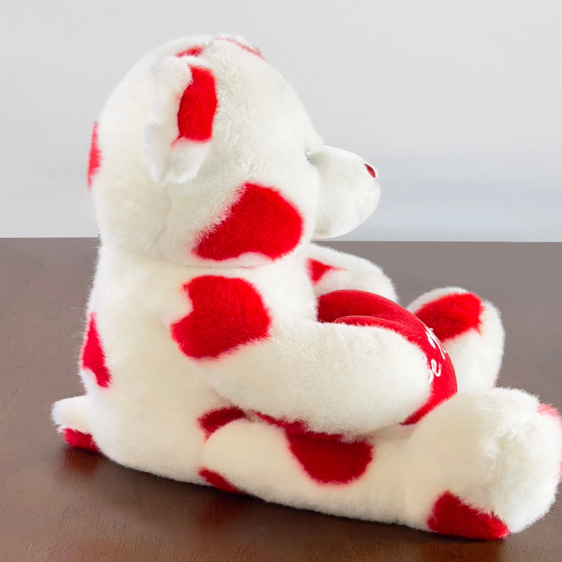 Carlton-Cards-White-Plush-Bear-with-Red-Hearts.-Side-view.