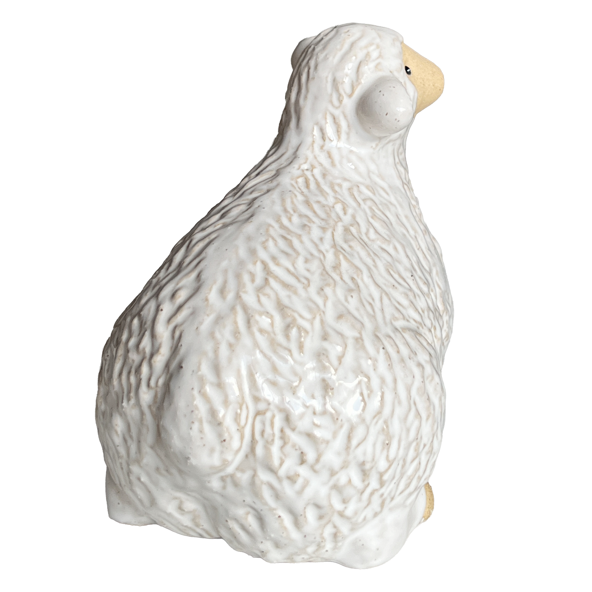 White ceramic sheep figurine view from the back.