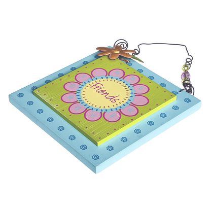 Decorative wall hanging with a floral design and 'Friends' text on a white background