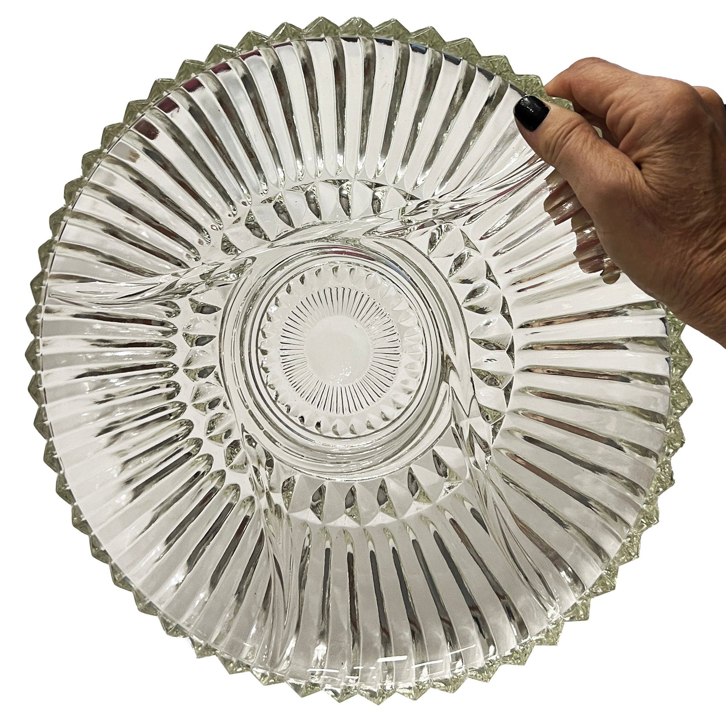 Clear glass dish held by a hand on a white background