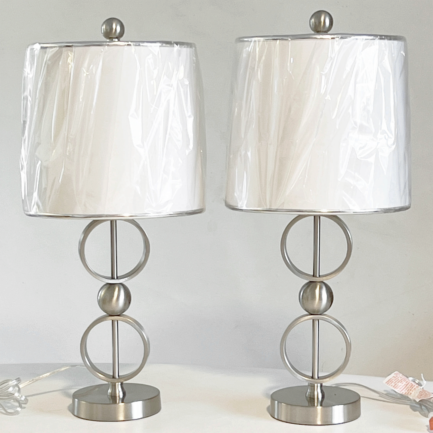 Lavish-Home-Brushed-Steel-Contemporary-Table-Lamp-Set.-View-shows-lamp-shades-covered-with-protective-wrapping.