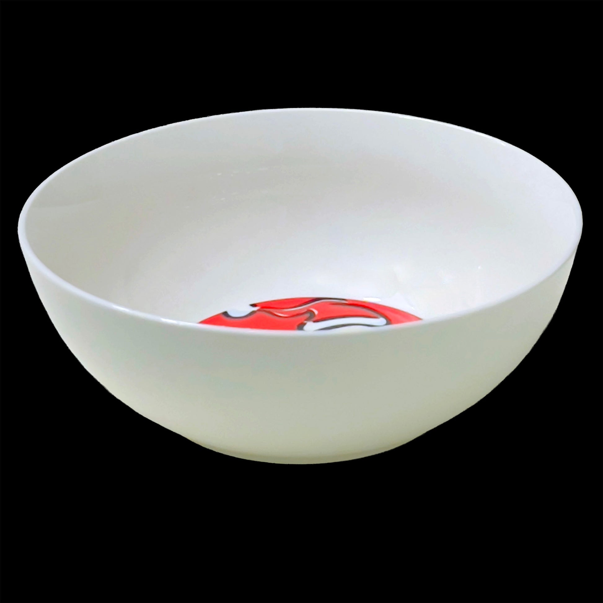 White ceramic bowl with a red and white design on a black background