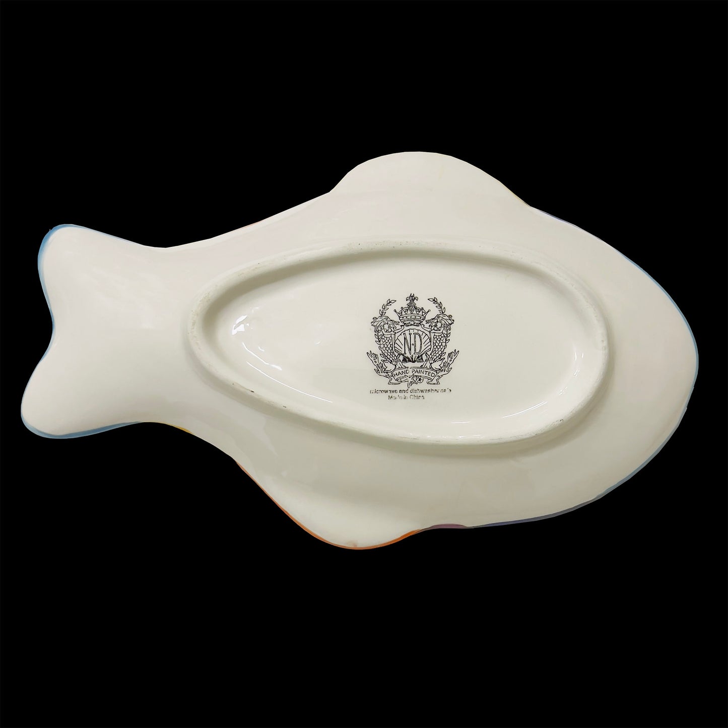White ceramic fish-shaped spoon rest with a black logo on a white background