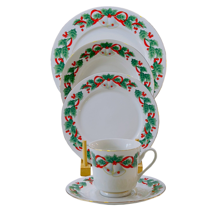 Set of Christmas-themed dinnerware with decorative patterns on a white background