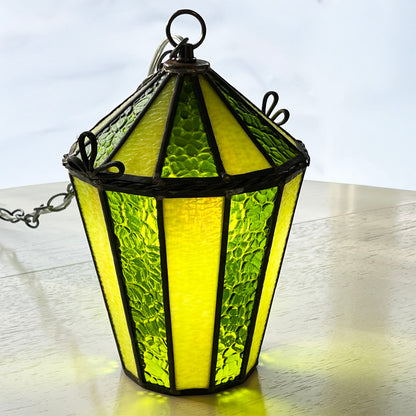 Green stained glass hanging lamp on a white surface