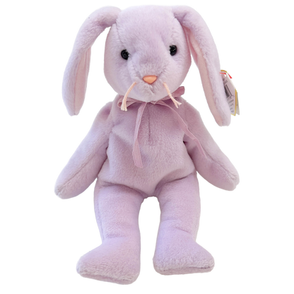 Pink plush bunny toy with a bow tie on a white background