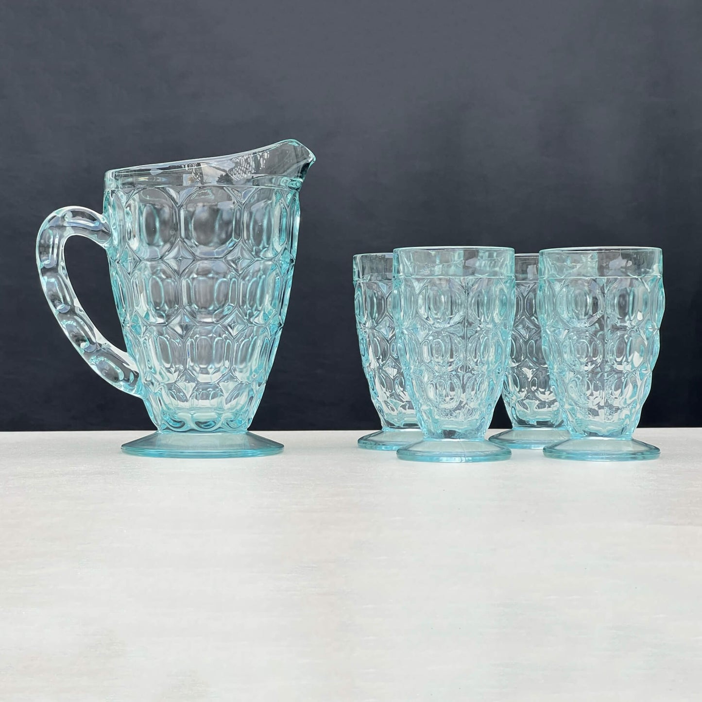 Jeannette-Pilgrim-Thumbprint-Glass-set-in-translucent-ice-blue.